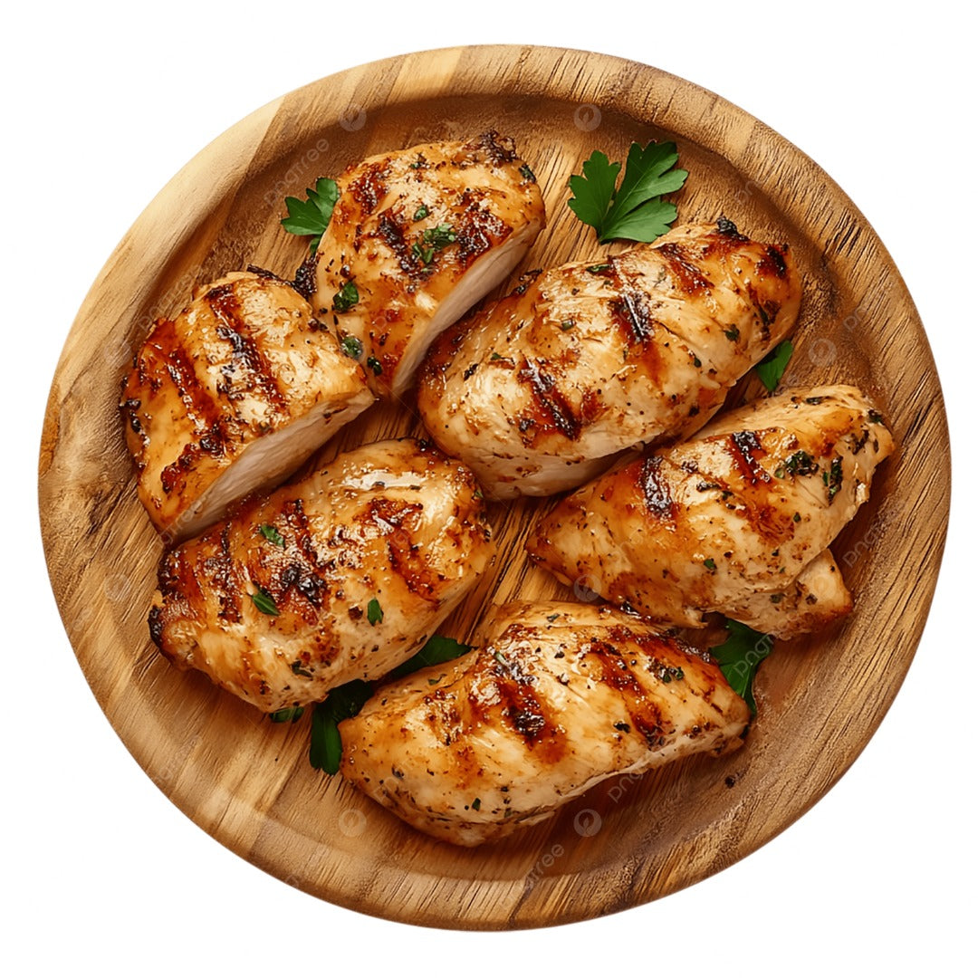 Chicken Fillet Grilled, featuring juicy fillets with perfect grill marks, is served on a round wooden plate and garnished with fresh parsley for a flavorful and appetizing meal.