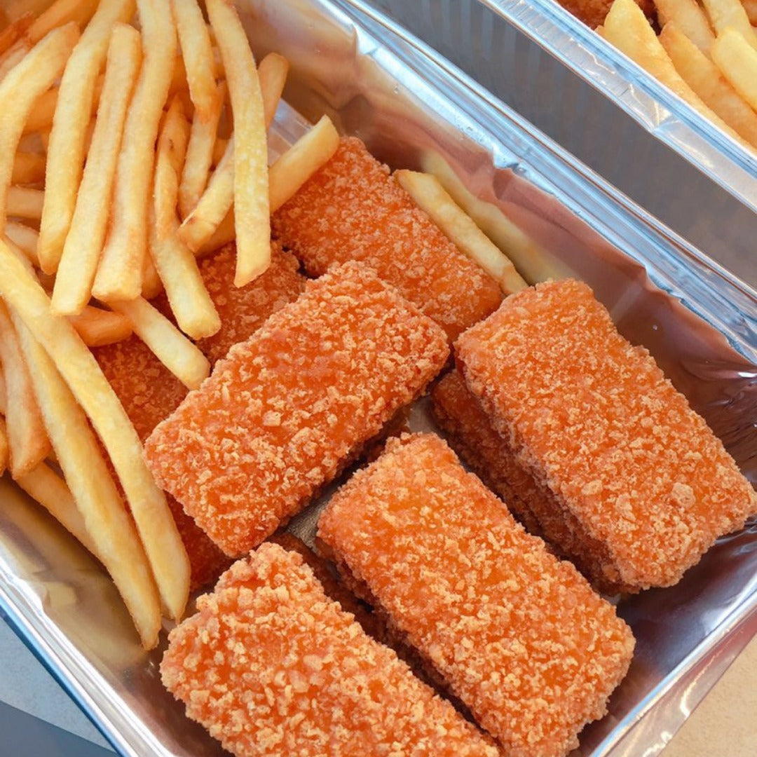 Mesahab takeout container featuring golden French fries and several rectangular fish sticks made from whole chicken pieces, not minced, for a natural taste—all arranged neatly inside.